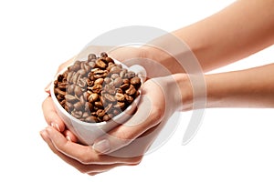 Woman hands holding coffee beans in cup isolated