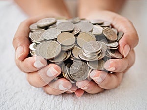 Woman hands holding coins on white background. saving money, fin