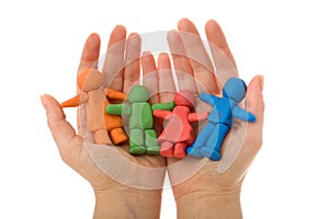 Woman hands holding colorful clay people family