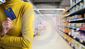 Woman hands holding credit card isolate on store background