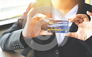 Woman hands holding credit card for online shopping in a office - working people paying technology money wallet online payment ,