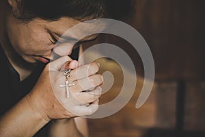 Woman hands holding crucified cross while praying God
