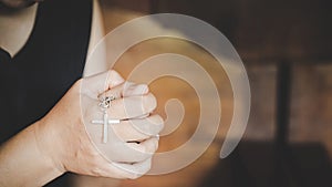 Woman hands holding crucified cross while praying God