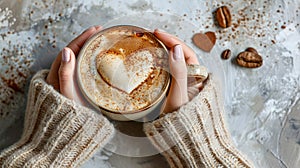 Woman hands holding cup of hot coffee latte cappuccino with heart shaped.