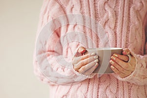 Woman hands holding cup of hot tea or coffee