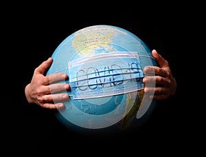 Woman hands holding the Earh globe in the doctor breath medicine mask