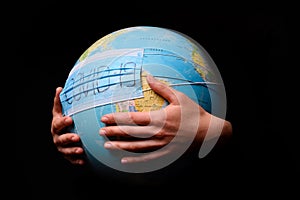 Woman hands holding the Earh globe in the doctor breath medicine mask