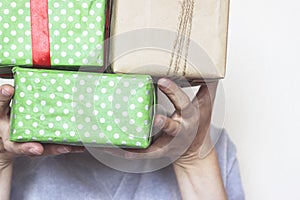 Woman hands holding gift boxes