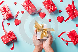 Woman hands holding gift or present box decorated and red heart surprise