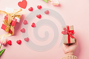 Woman hands holding gift or present box decorated and red heart surprise