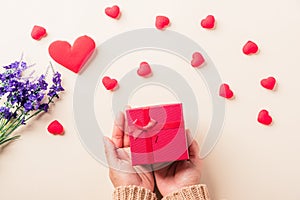 Woman hands holding gift or present box decorated and red heart surprise