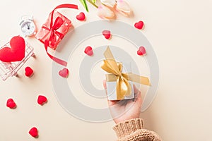 Woman hands holding gift or present box decorated and red heart surprise