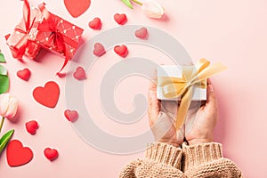 Woman hands holding gift or present box decorated and red heart surprise