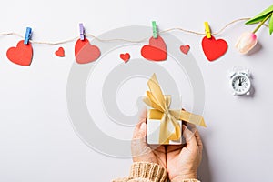 Woman hands holding gift or present box decorated and red heart surprise