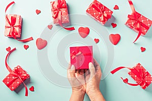 Woman hands holding gift or present box decorated and red heart surprise