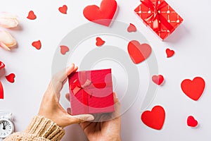 Woman hands holding gift or present box decorated and red heart surprise