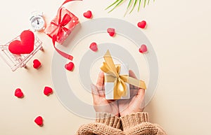 Woman hands holding gift or present box decorated and red heart surprise