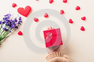 Woman hands holding gift or present box decorated and red heart surprise