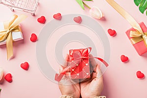 Woman hands holding gift or present box decorated and red heart surprise