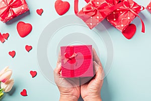 Woman hands holding gift or present box decorated and red heart surprise