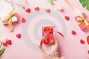 Woman hands holding gift or present box decorated and red heart surprise