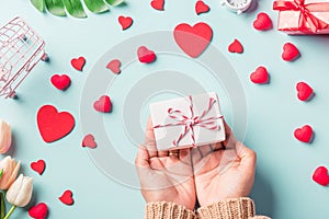 Woman hands holding gift or present box decorated and red heart surprise