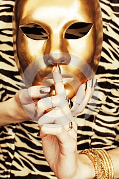 Woman hands holding golden carnival mask, rich luxury manicure a