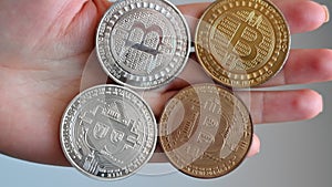 Woman hands holding golden and silver bitcoin crypto currency close up