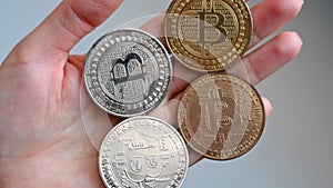 Woman hands holding golden and silver bitcoin crypto currency close up