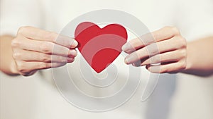 Woman hands holding Heart shape Love symbol