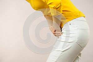 Woman with hands holding her crotch