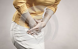 Woman with hands holding her crotch