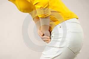 Woman with hands holding her crotch