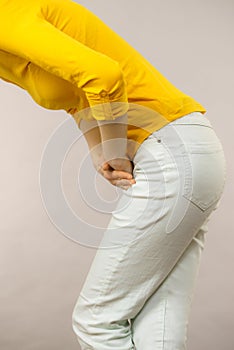 Woman with hands holding her crotch