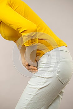 Woman with hands holding her crotch