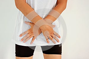 Woman with hands holding her crotch