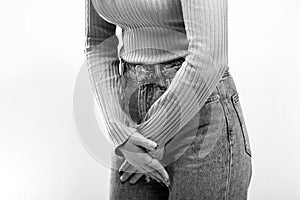 Woman Hands Holding Her Crotch. Sick woman hands holding pressing her crotch lower abdomen. Black and white