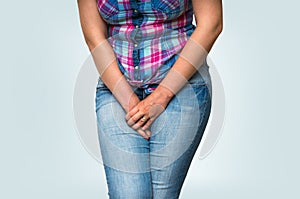 Woman with hands holding her crotch, she wants to pee photo