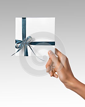 Woman Hands holding Holiday Present White Box with Blue Ribbon on a White Background