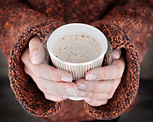 Woman hands holding a hot drink