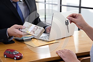 Woman hands holding keys submit to the bank.