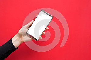 Woman hands holding mobile phone with blank white screen