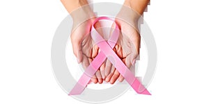 Woman hands holding pink ribbon over transparent white background, breast cancer awareness, cancer awareness day