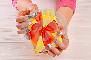 Woman hands holding present box.