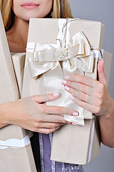 Woman hands holding present boxes