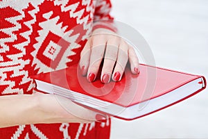 Woman hands holding red diary