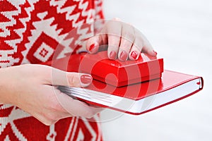 Woman hands holding red diary