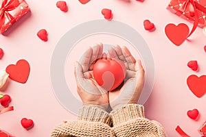 Woman hands holding red heart and have gift or present box decorated surprise