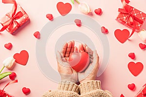 Woman hands holding red heart and have gift or present box decorated surprise