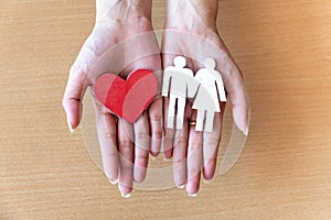 Woman hands holding red heart and icon family, health care, family insurance concept